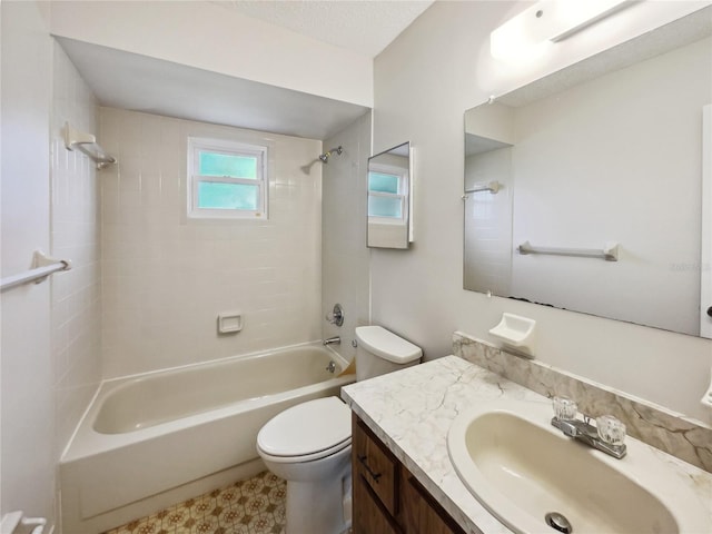 full bathroom featuring toilet, tiled shower / bath, a textured ceiling, and vanity