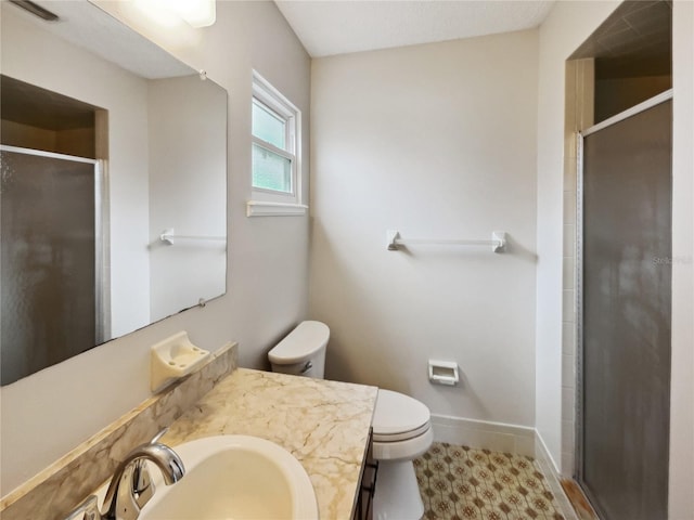 bathroom with vanity, toilet, tile patterned floors, and walk in shower