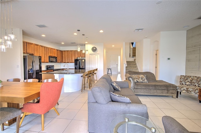 living room with sink and light tile patterned floors