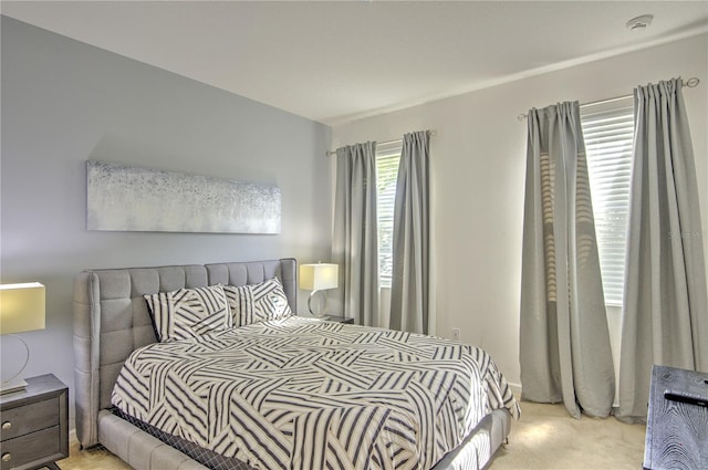 bedroom featuring light colored carpet