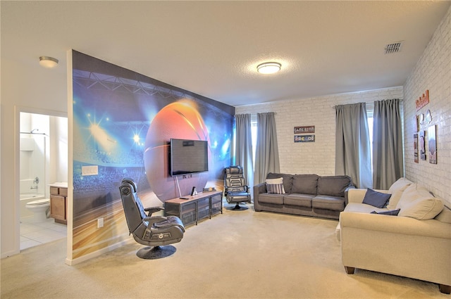 living room with a textured ceiling, light colored carpet, and brick wall