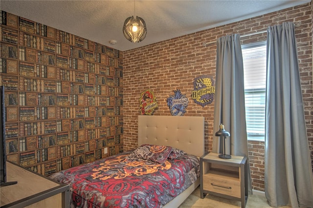 carpeted bedroom featuring a textured ceiling and brick wall