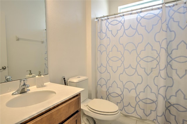 bathroom featuring curtained shower, tile patterned flooring, vanity, and toilet