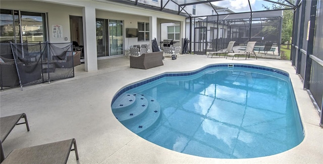 view of pool featuring a patio and glass enclosure