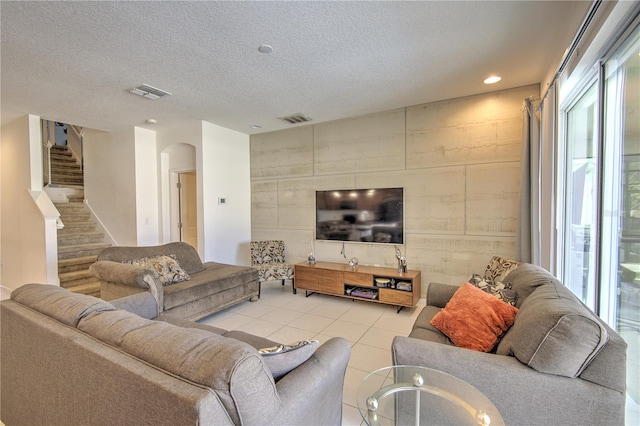 tiled living room with a textured ceiling