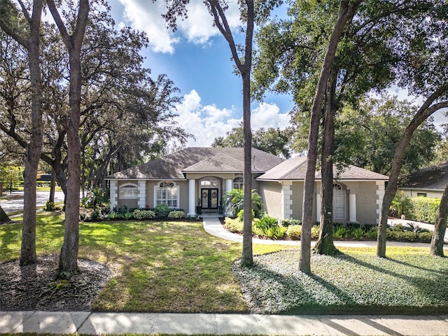 ranch-style home featuring a front lawn