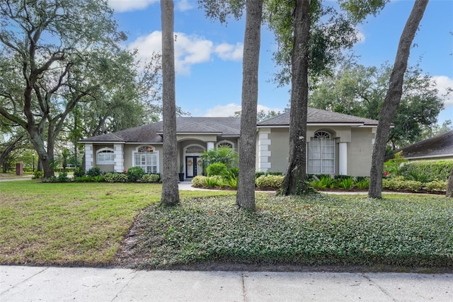 single story home featuring a front yard