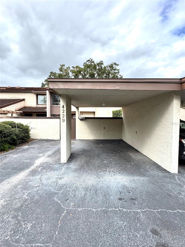 view of vehicle parking with a carport