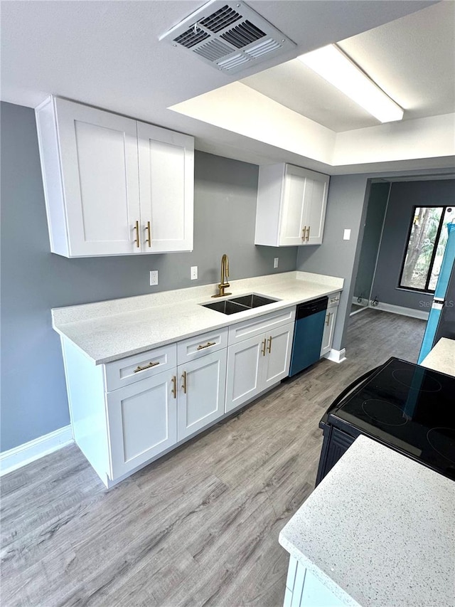 kitchen featuring light hardwood / wood-style flooring, white cabinetry, dishwasher, and sink