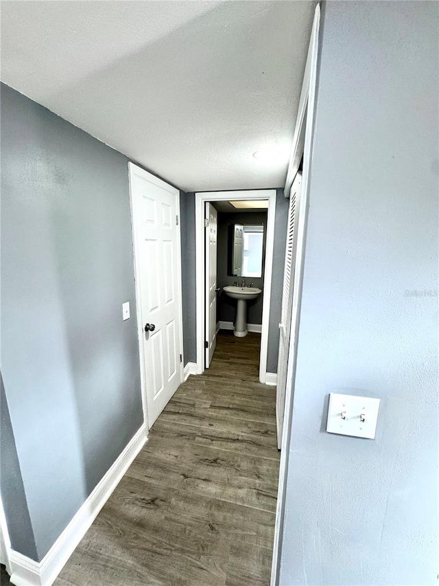 corridor with dark wood-type flooring