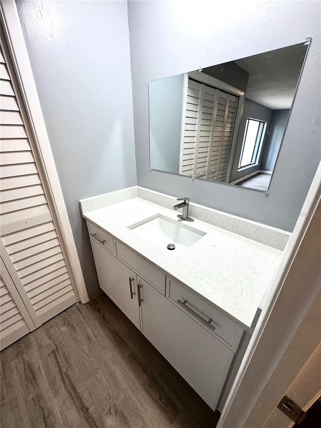 bathroom with vanity and hardwood / wood-style flooring