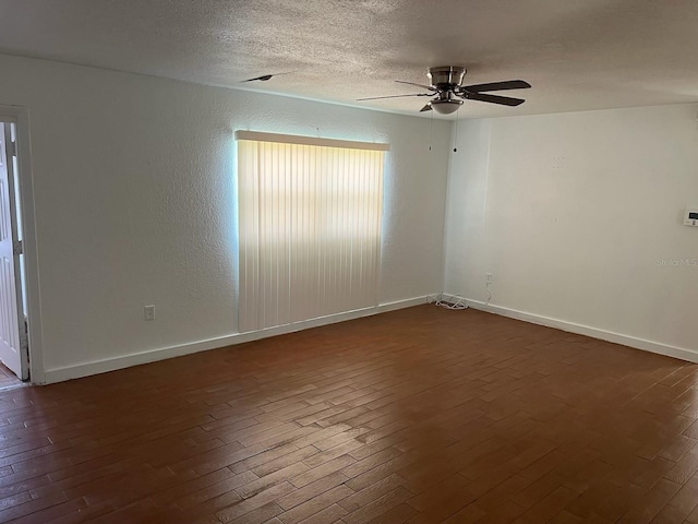 unfurnished room featuring ceiling fan and dark hardwood / wood-style floors