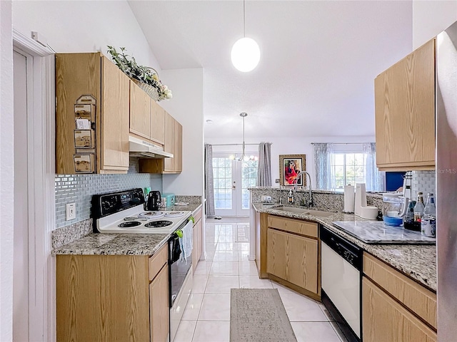 kitchen with backsplash, sink, pendant lighting, and white appliances