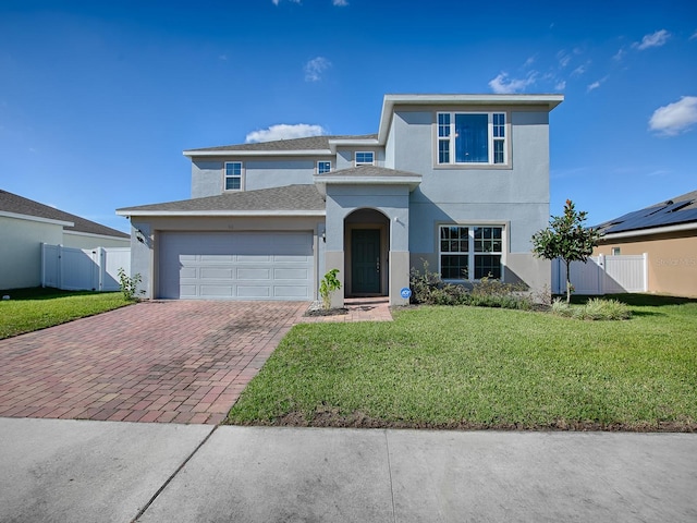 front of property with a garage and a front lawn