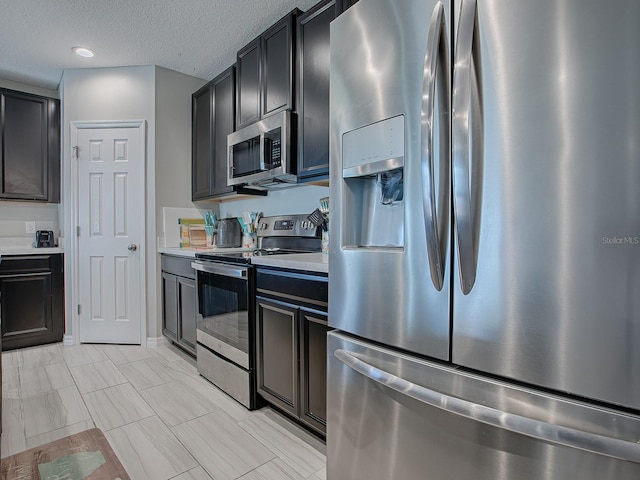 kitchen featuring stainless steel appliances and a textured ceiling