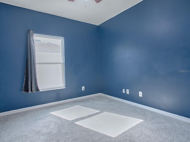 empty room with ceiling fan and carpet floors