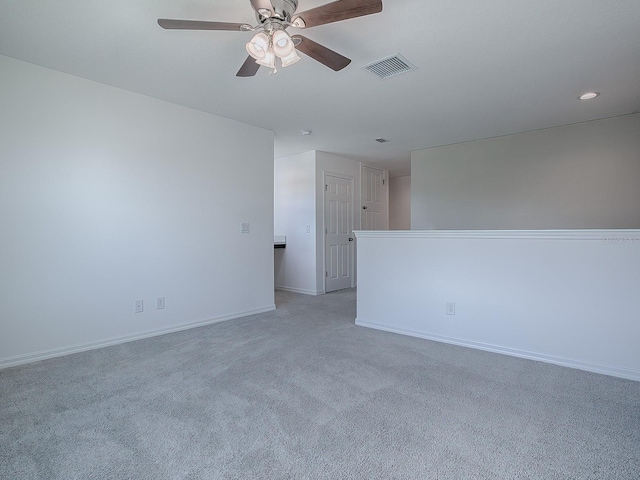 spare room with light carpet and ceiling fan