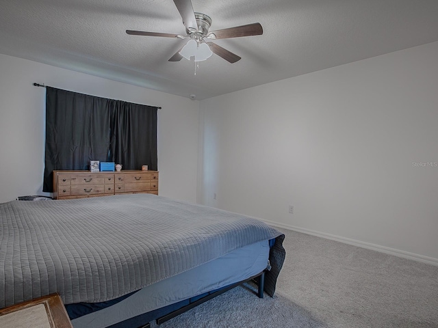 bedroom featuring carpet, a textured ceiling, and ceiling fan