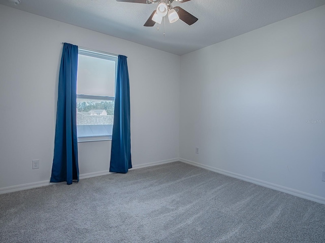 carpeted empty room featuring ceiling fan and a textured ceiling