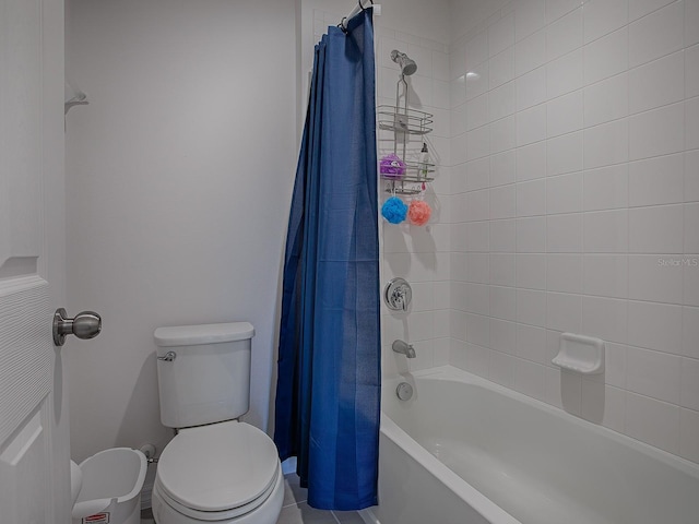 bathroom featuring shower / tub combo and toilet