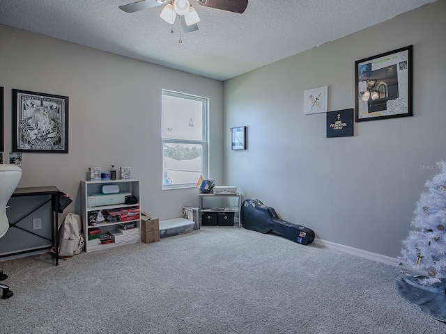 miscellaneous room featuring carpet flooring, a textured ceiling, and ceiling fan