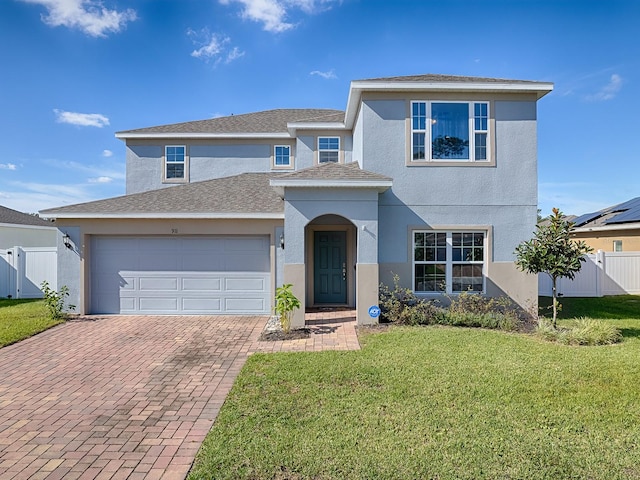 front facade featuring a front yard and a garage