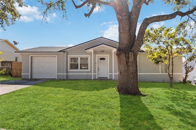 ranch-style house featuring a garage and a front lawn