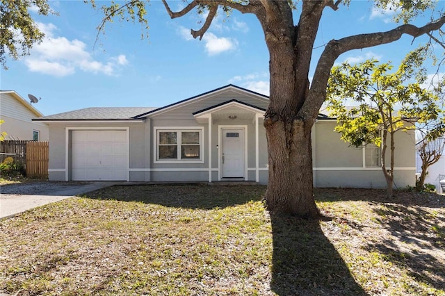 ranch-style home featuring a garage and a front lawn