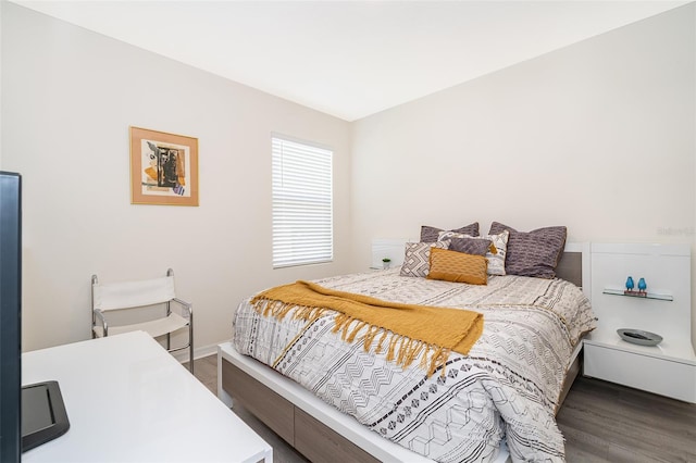 bedroom with dark wood-type flooring