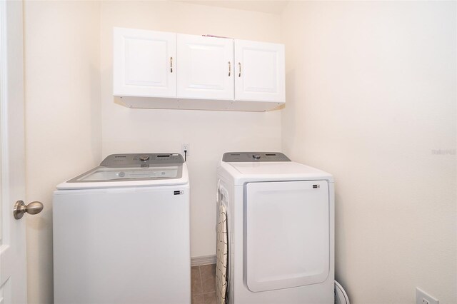 clothes washing area with cabinets, separate washer and dryer, and tile patterned flooring