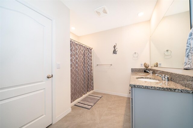 bathroom featuring vanity, curtained shower, and tile patterned flooring