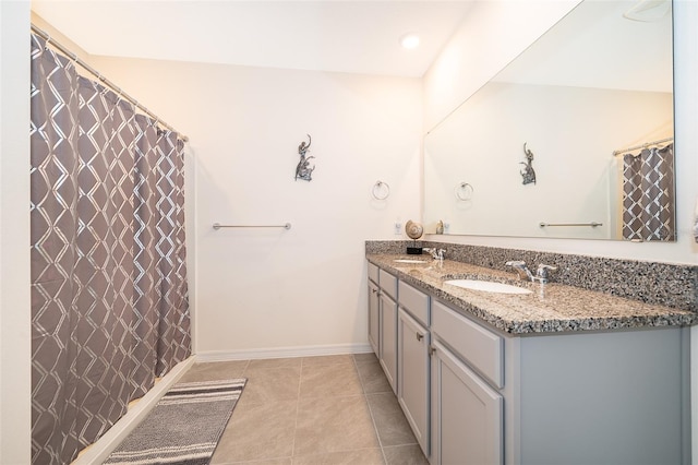 bathroom with vanity, curtained shower, and tile patterned flooring