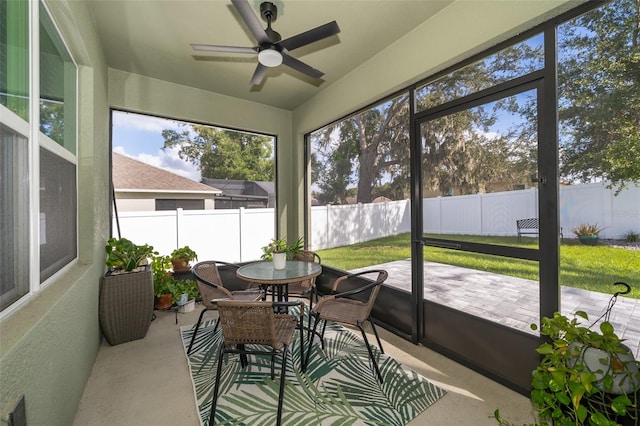 sunroom with ceiling fan and plenty of natural light