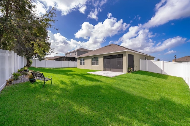 back of house featuring a patio and a yard