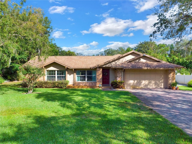 single story home with a garage and a front lawn