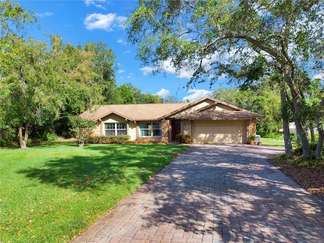 single story home featuring a garage and a front yard