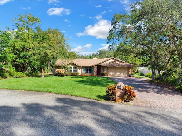 view of front of home with a front lawn and a garage