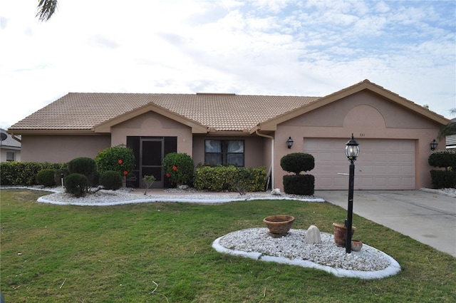 single story home featuring a front yard and a garage