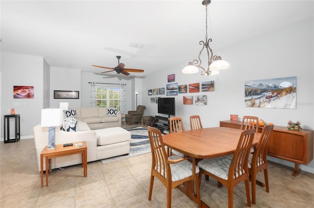 dining space featuring ceiling fan with notable chandelier