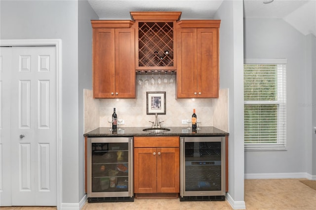 bar featuring tasteful backsplash, beverage cooler, and dark stone counters