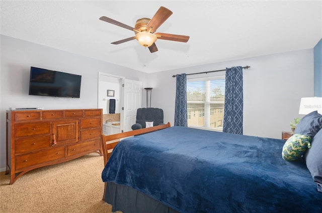 carpeted bedroom with ceiling fan and ensuite bathroom