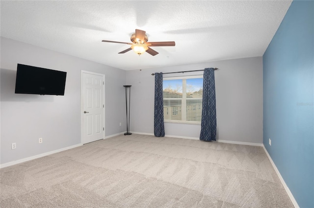 unfurnished room with light carpet, a textured ceiling, and ceiling fan