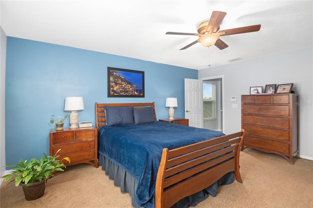 bedroom with ceiling fan and light carpet