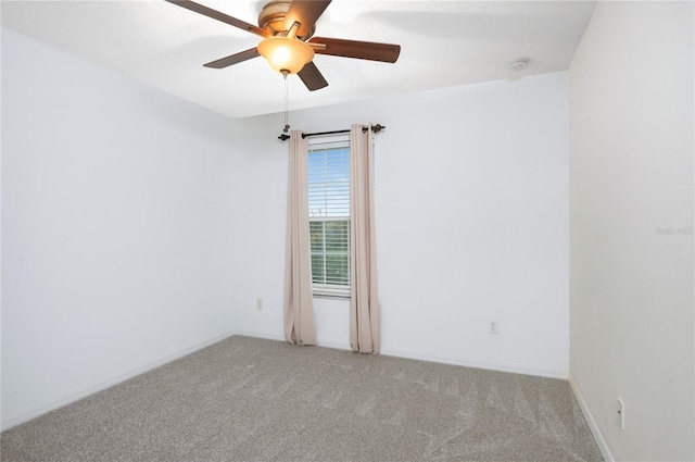 empty room featuring light colored carpet and ceiling fan