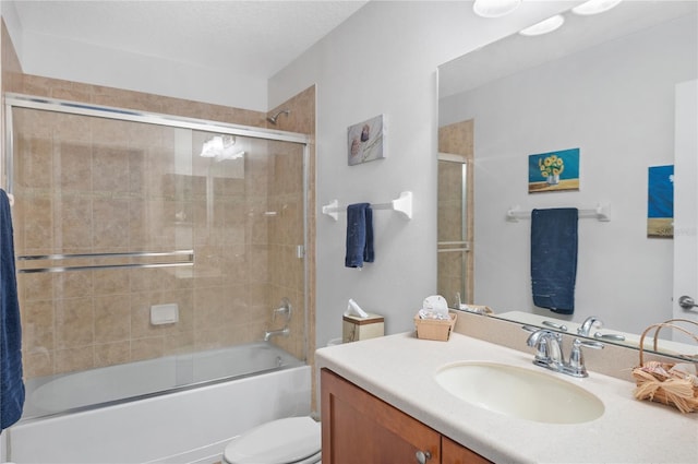 full bathroom featuring toilet, vanity, shower / bath combination with glass door, and a textured ceiling