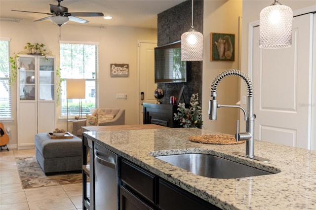 kitchen with a sink, dishwasher, ceiling fan, light tile patterned floors, and pendant lighting