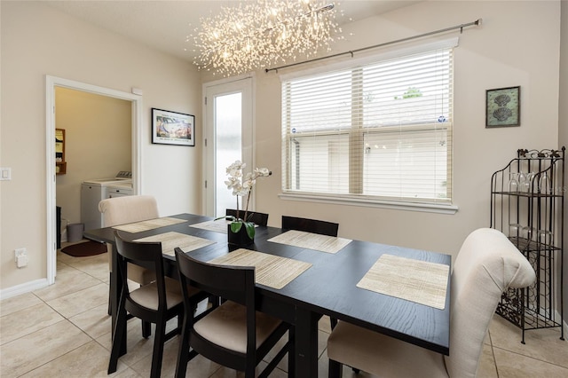 dining area featuring washing machine and dryer and light tile patterned floors