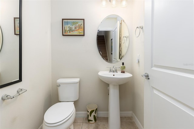 bathroom featuring toilet and tile patterned floors