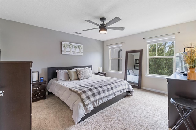 carpeted bedroom with baseboards and ceiling fan