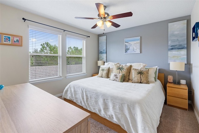 bedroom with baseboards, ceiling fan, and carpet flooring